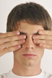 "Young male adult;hands covering eyes"